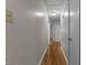 Hallway view with hardwood flooring, neutral walls, and white trim at 807 New St, Graham, NC 27253