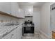 An updated kitchen with stainless steel appliances, including a gas range at 807 New St, Graham, NC 27253