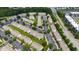 This aerial view features townhomes with parking, manicured lawns, mature trees and nearby highway at 818 Bryant St, Raleigh, NC 27603
