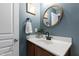 Bathroom with a modern vanity featuring a dark wood cabinet, white countertop, and sleek, black fixtures at 818 Bryant St, Raleigh, NC 27603