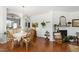 Bright dining area with modern chandelier, open to the kitchen, with hardwood floors and tasteful decor at 818 Bryant St, Raleigh, NC 27603