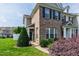 Inviting townhouse with brick facade, dark shutters, and mature landscaping creating a warm entrance at 818 Bryant St, Raleigh, NC 27603