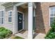 Welcoming front door adorned with a wreath, framed by white columns and lush greenery at 818 Bryant St, Raleigh, NC 27603