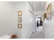Hallway with neutral carpeting, white trim, and decor leading to a brightly lit room at 818 Bryant St, Raleigh, NC 27603