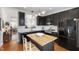 Well-equipped kitchen featuring dark cabinets, stainless steel appliances, and central island at 818 Bryant St, Raleigh, NC 27603