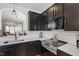 Modern kitchen with dark cabinets, stainless steel appliances, and white quartz countertops at 818 Bryant St, Raleigh, NC 27603