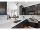 Modern kitchen features dark cabinets, stainless steel appliances, and white quartz countertops at 818 Bryant St, Raleigh, NC 27603
