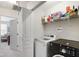 Well-equipped laundry room with modern washer and dryer, and storage shelves at 818 Bryant St, Raleigh, NC 27603