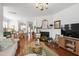 Spacious open-concept living area with fireplace, hardwood floors, and seamless flow to the dining room at 818 Bryant St, Raleigh, NC 27603