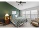 Cozy bedroom with a ceiling fan, green accent wall, and lots of natural light at 818 Bryant St, Raleigh, NC 27603