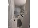 This tiled bathroom has a shower with decorative blue shower curtain, shelves, and modern vanity at 908 E Hudson Ave, Durham, NC 27704