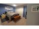 A bright bedroom featuring beach decor and furnishings, a wooden chest, and carpet flooring at 908 E Hudson Ave, Durham, NC 27704