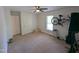 An ample bedroom with carpet flooring, ceiling fan, and window with mounted bicycle display at 908 E Hudson Ave, Durham, NC 27704