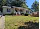 Charming single-story home with a well-maintained lawn and inviting front porch at 908 E Hudson Ave, Durham, NC 27704
