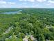 Aerial view showcasing the property's location near a lake and surrounded by lush greenery at 9508 Waterwood Ct, Raleigh, NC 27614