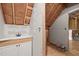Unfinished attic bathroom displaying a vanity and open framework, ready for customization at 9508 Waterwood Ct, Raleigh, NC 27614