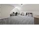 Large bonus room with angled ceilings, gray carpet, and an area set up for music and working at 9508 Waterwood Ct, Raleigh, NC 27614