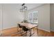Dining room featuring wood floors, modern light fixture, and large window at 9508 Waterwood Ct, Raleigh, NC 27614