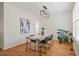 Bright dining room featuring a wooden table, modern lighting, and stylish decor, perfect for Gathering gatherings at 9508 Waterwood Ct, Raleigh, NC 27614