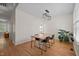 Another view of dining room with wood floors, modern light fixture, and plant at 9508 Waterwood Ct, Raleigh, NC 27614