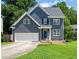 Charming two-story home with blue siding, white trim, two car garage, and well-manicured lawn at 9508 Waterwood Ct, Raleigh, NC 27614
