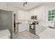 Well-lit kitchen with white cabinetry, stainless steel appliances, and a functional layout for easy cooking and meal preparation at 9508 Waterwood Ct, Raleigh, NC 27614
