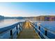 Wooden pier on lake perfect for a lakeside retreat, offering calming blue waters at 9508 Waterwood Ct, Raleigh, NC 27614
