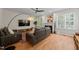 Cozy living room with hardwood floors, modern furnishings, and a view of the backyard at 9508 Waterwood Ct, Raleigh, NC 27614