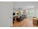 Spacious living room with hardwood floors, fireplace, and large windows providing plenty of natural light at 9508 Waterwood Ct, Raleigh, NC 27614