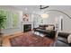 Living room with hardwood floors, fireplace, rug, and leather couches at 9508 Waterwood Ct, Raleigh, NC 27614