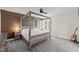 Spacious main bedroom with a four-poster bed, neutral carpet, and a ceiling fan at 9508 Waterwood Ct, Raleigh, NC 27614