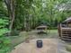 Landscaped backyard featuring gazebo with lounge furniture and outdoor fire pit area at 1005 Fairfax Woods Dr, Apex, NC 27502