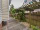 Stone patio with a charming pergola and garden, creating an inviting outdoor space at 1005 Fairfax Woods Dr, Apex, NC 27502