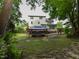 Expansive backyard features deck, gazebo with seating, and a well-manicured lawn at 1005 Fairfax Woods Dr, Apex, NC 27502