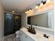 Bathroom showcasing double sinks, a large framed mirror, and a glass-enclosed shower at 1005 Fairfax Woods Dr, Apex, NC 27502