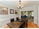 Formal dining room with hardwood floors, elegant chandelier, and decorative wall art at 1005 Fairfax Woods Dr, Apex, NC 27502