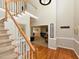 Bright foyer featuring hardwood floors, a staircase, and access to the living spaces at 1005 Fairfax Woods Dr, Apex, NC 27502