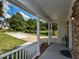 Inviting front porch with white columns offering a view of the driveway and front yard at 1005 Fairfax Woods Dr, Apex, NC 27502
