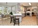 Modern eat-in kitchen with stainless steel appliances, quartz countertops, and tile flooring at 1005 Fairfax Woods Dr, Apex, NC 27502