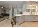 Open-concept kitchen with island and seating, flowing seamlessly into the living area at 1005 Fairfax Woods Dr, Apex, NC 27502
