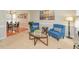 Cozy living room with two blue chairs, an oval coffee table, and view into the dining room at 1005 Fairfax Woods Dr, Apex, NC 27502