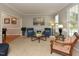 Bright living room featuring comfortable seating, large windows, and neutral decor at 1005 Fairfax Woods Dr, Apex, NC 27502