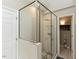 Modern shower with glass surround and decorative tile flooring at 1005 Fairfax Woods Dr, Apex, NC 27502