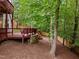 Large wooden deck overlooking a lush, wooded backyard with mulched ground cover at 105 Jolyn Pl, Chapel Hill, NC 27517