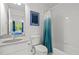 Well-lit bathroom with shower-tub combo and coordinated blue shower curtain and decor at 105 Jolyn Pl, Chapel Hill, NC 27517