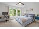 Bright bedroom features modern bed, desk with chair, large window with outside views at 105 Jolyn Pl, Chapel Hill, NC 27517