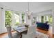 Spacious dining room with natural light, hardwood floors, and open view into the adjacent living room at 105 Jolyn Pl, Chapel Hill, NC 27517