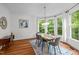 Bright dining area featuring a large bay window providing scenic outdoor views and natural light at 105 Jolyn Pl, Chapel Hill, NC 27517