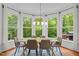 Cozy dining room with large windows, modern lighting, and a stylish dining table set for six at 105 Jolyn Pl, Chapel Hill, NC 27517