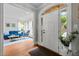 Inviting foyer with hardwood floors, white front door and an archway leading to a bright living room at 105 Jolyn Pl, Chapel Hill, NC 27517